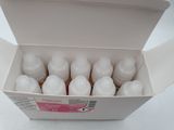 a white box filled with bottles of liquid on a white surface