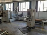 a machine that is working on a piece of wood in a factory