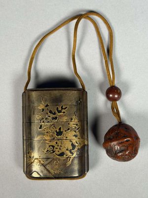 an old metal case with a wooden bead on a string