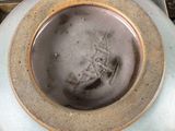 a bowl with a brown rim sitting on a plate