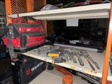 many tools on a shelf in a garage