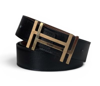 a close up of a black belt with a gold buckle
