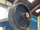 an image of a machine in a workshop with a large wheel