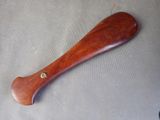a wooden baseball bat laying on a table next to a pair of scissors