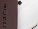 a brown box with a white shirt inside of it
