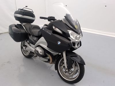 a black and silver motorcycle parked in a white room