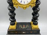 a black and gold clock sitting on a table