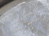 a close up of a silver plate with writing on it