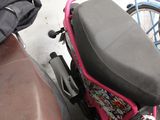 a pink motorcycle parked next to a brown table