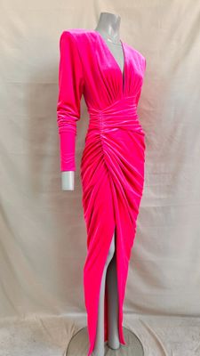 the dress is pink and has long sleeves and a side slit