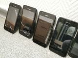 five cell phones are lined up in a row with a broken screen