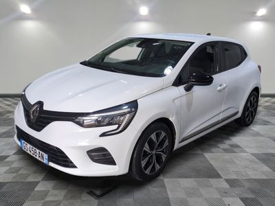 the white car is parked on a checkered floor in a garage
