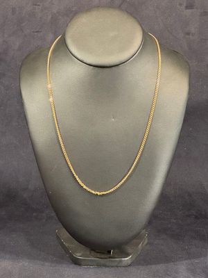 a mannequin with a gold chain on it