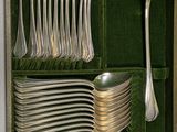 a green case with silverware and spoons in it
