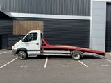 a white truck with a flat bed parked in a parking lot