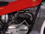 a red motorcycle that is parked in a garage