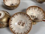 many different types of teapots and cups on the table