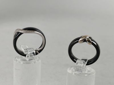 pair of black and white rings on clear acrylic stand