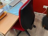 a desk with a computer monitor, keyboard, mouse, and other items on it