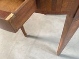 a wooden table with a glass top and a drawer