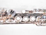 a flute that is sitting on a white surface
