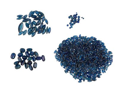 some blue glass beads are arranged in a circle on a white surface