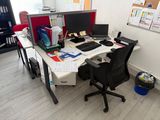 a desk with a chair and a computer on it