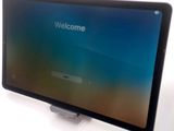 a tablet that is sitting on a table with a welcome screen
