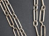 a close up of a necklace with a chain attached to it