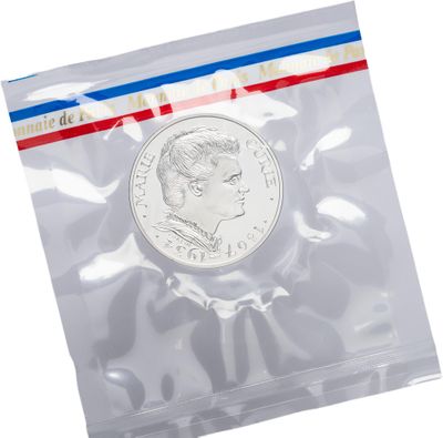 a close up of a coin in a plastic bag on a white background