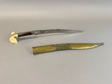 pair of gold plated knives on a white surface with a knife in the foreground