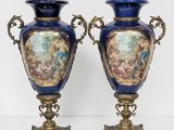 pair of blue and gold vases sitting on top of a table