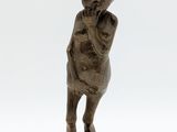 statue of a man with a hat on his head holding a baby