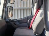 a seat in the back of a truck with a red seat belt
