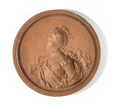 portrait of a woman in a dress and hat in a bronze medallion