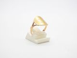gros plan d'une bague en or sur une surface blanche