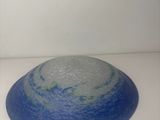 a blue and white bowl sitting on a white table