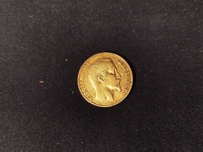 a gold coin with a profile of a man on it