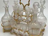 bottles and glasses on a gold stand with a heart in the middle