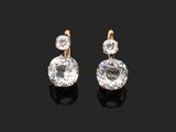 a pair of diamond and gold earrings