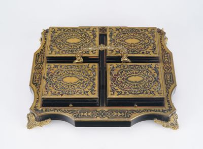 a black and gold box on a white surface