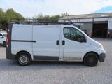 a white van parked in a parking lot next to a building