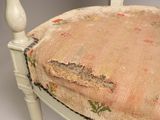 a chair that has a cushion on the back of it
