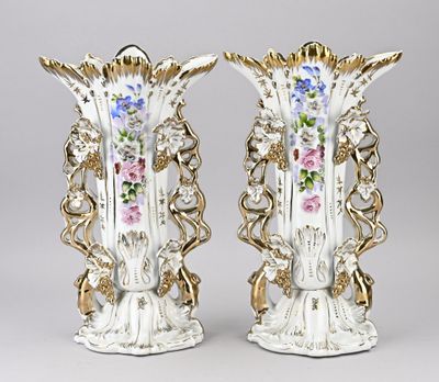 pair of antique porcelain vases with floral designs on them