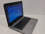 a laptop computer sitting on a table with a blue screen