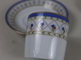 a cup and saucer sitting on a table