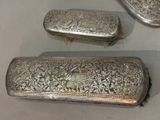 two silver boxes that are sitting on a table