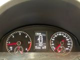 a close up of a car ' s dashboard with various gauges