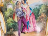 a vase with a painting of a man and a woman on it