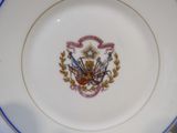 a plate with a picture of a coat of arms on it